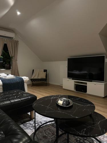 a living room with a large flat screen tv at Landvetter Airport B&B in Härryda