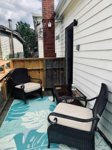 a patio with two chairs and a table on a porch at Pet-Friendly Space #3 at Doggy Digs, King Bed and Office in Halifax