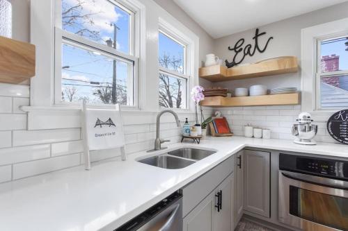 a white kitchen with a sink and two windows at BikeslParkPasslPizzaOvenlSnoConelYouTubeTVlEV in Greenville