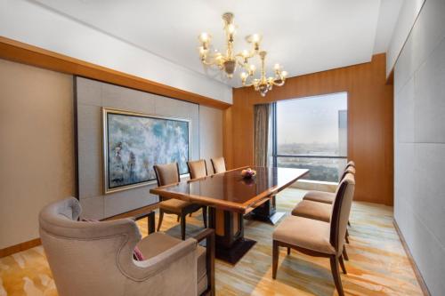 a dining room with a table and chairs and a chandelier at InterContinental Changzhou by IHG in Changzhou