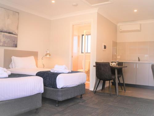 Ένα ή περισσότερα κρεβάτια σε δωμάτιο στο Eastend Studio Apartments