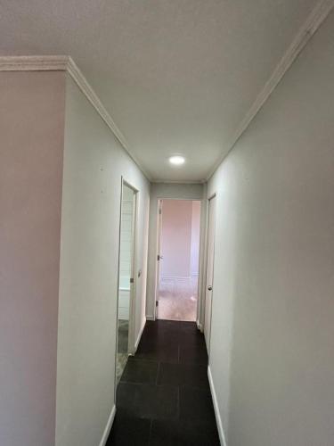 an empty hallway with a hallway leading to a room at Departamento Cómodo en Santiago in Santiago