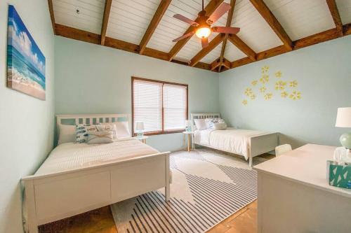 a bedroom with two beds and a ceiling fan at Private Oasis with Incredible Views in St Thomas