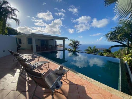 a villa with a swimming pool with a view of the ocean at Private Oasis with Incredible Views in St Thomas