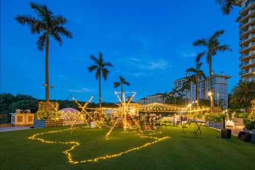 a park with lights and palm trees at night at Mission Hills Hotel Resorts Dongguan in Dongguan