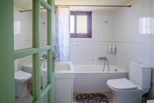 een badkamer met een bad, een toilet en een wastafel bij Nature's Playground Cottage new listing2024 in Chania