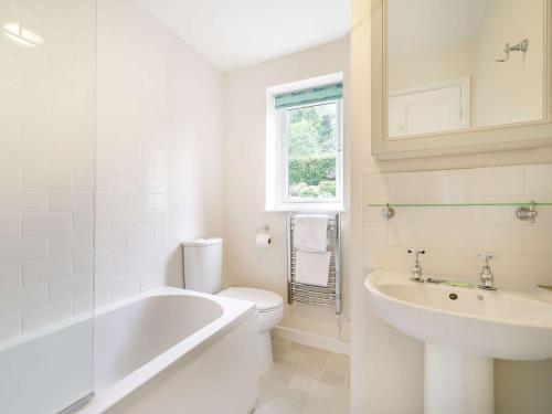 a bathroom with a tub and a toilet and a sink at 2 Bed in Fowey 73074 in Fowey