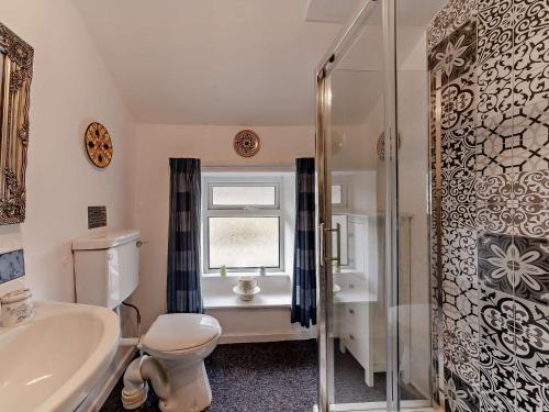 a bathroom with a toilet and a sink and a shower at 2 Bed in Blanchland 91440 