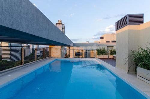 a swimming pool on the roof of a building at Modern 2 Bedroom Apartment Near Paseo La Galeria in Asuncion