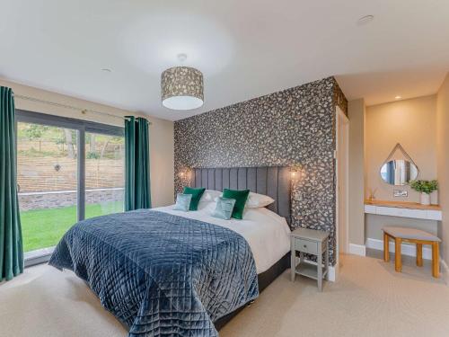 a bedroom with a large bed and a large window at 3 Bed in Montgomery 88641 in Llandyssil