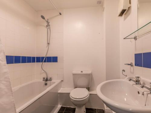 a bathroom with a toilet and a tub and a sink at 3 Bed in Croyde 87752 in Croyde