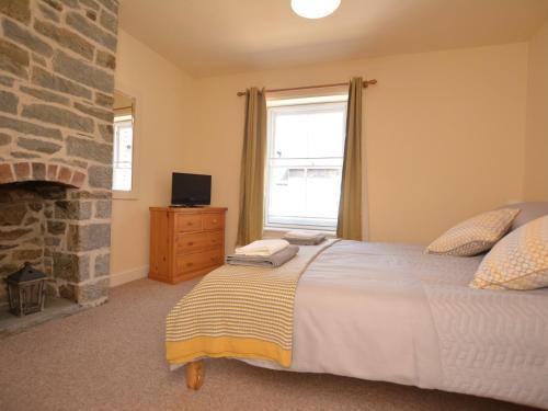 a bedroom with a large bed and a fireplace at 2 Bed in Knighton 62209 in Knighton