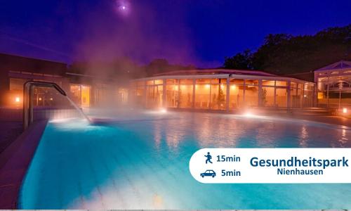 a large building with a swimming pool at night at Themenpartment Himmel und Mehr Penthouse in Gelsenkirchen