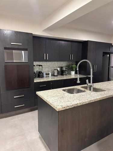 a kitchen with a sink and a microwave at Urban Circunvalación in Guadalajara
