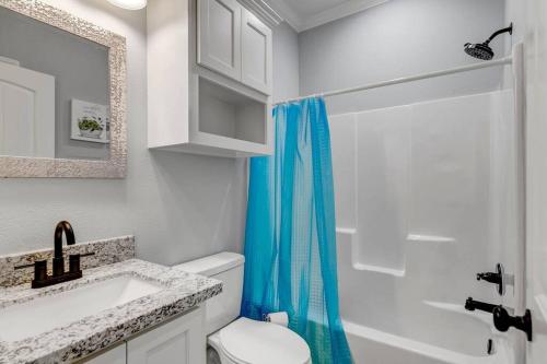 a bathroom with a toilet and a sink and a shower at Reduced! Renovated hidden gem. Chef Kitch. Wheelch in Beaumont