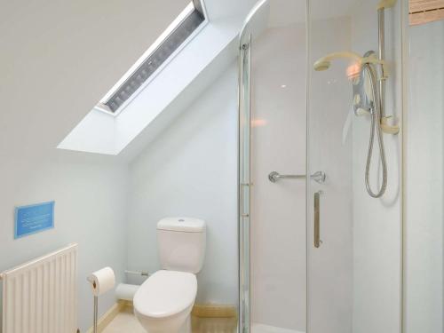 a bathroom with a toilet and a glass shower at 4 Bed in AYR 90038 in Ayr