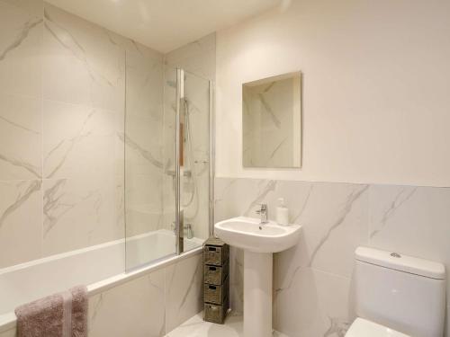 a bathroom with a sink and a shower and a toilet at 3 Bed in Denby Dale 88924 in Denby Dale