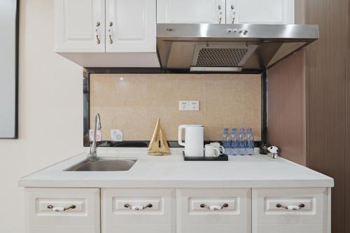 a kitchen with a sink and a counter top at East Maple International Apartment - Guangzhou Luogang Wanda Plaza Suyuan Metro Station in Guangzhou