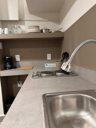 a kitchen with a sink and a counter top at Urban Circunvalación in Guadalajara