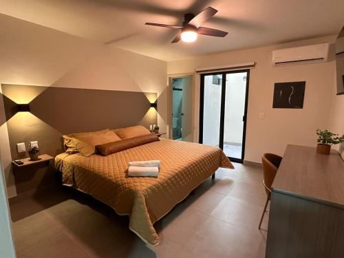 a bedroom with a bed and a ceiling fan at Urban Circunvalación in Guadalajara