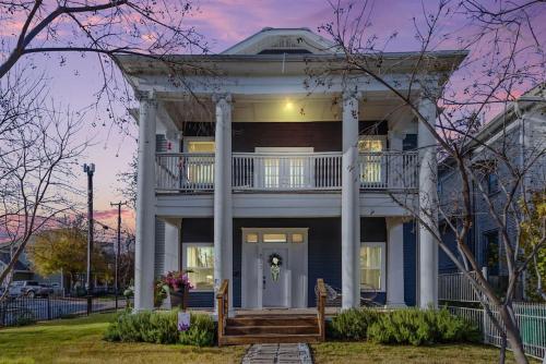 a large white house with a porch and columns at Reduced! Casa Paz - Historic Home Walking Distance in San Antonio