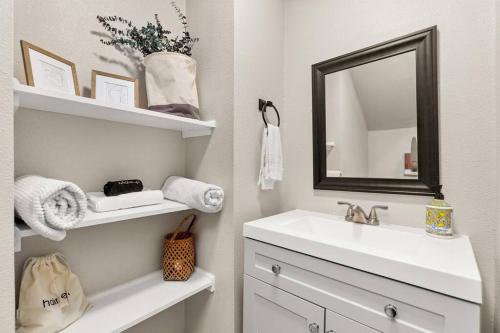 a bathroom with a sink and a mirror at Reduced! Casa Paz - Historic Home Walking Distance in San Antonio