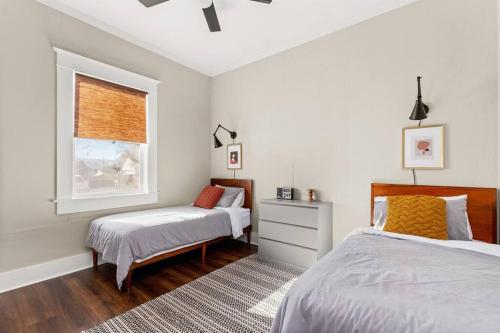 a bedroom with two beds and a window at Reduced! Casa Paz - Historic Home Walking Distance in San Antonio