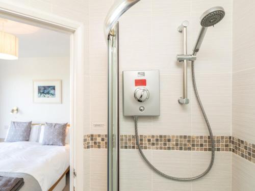 a shower in a bathroom with a bed at 5 Bed in Mortehoe 76593 in Mortehoe