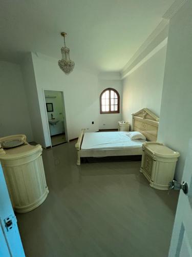 a bedroom with a bed and two trash cans at Hermoso PH con parrillera in La Victoria