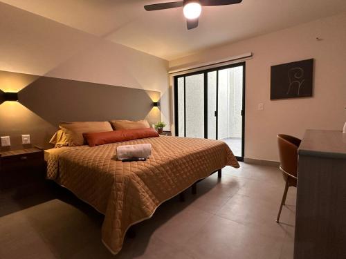 a bedroom with a bed and a large window at Urban Circunvalación in Guadalajara