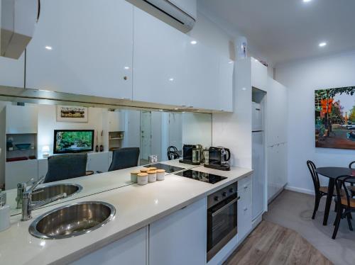 a kitchen with two sinks and a counter top at Oversized Potts Point Studio in Sydney
