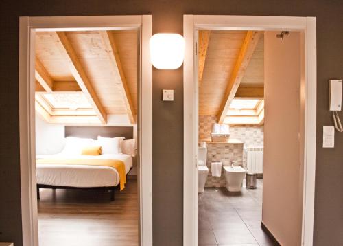 1 dormitorio con 1 cama en una habitación con techo en Lux Apartamentos Santiago, en Santiago de Compostela
