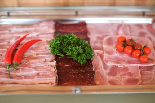a display of meat and vegetables on a tray at Arosa Vetter Hotel in Arosa