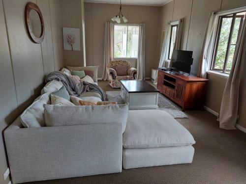 sala de estar con sofá y TV en Amaroo House 'A beautiful place!', en Lyra