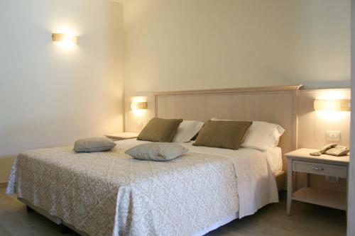 a bedroom with a bed with two pillows on it at Hotel Marana in Golfo Aranci