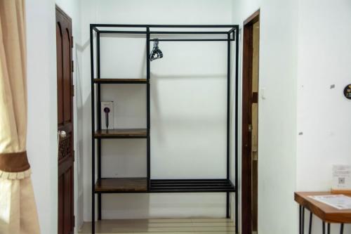 a glass door with a shelf in a room at Amara Beach Resort Koh Phangan in Haad Yao