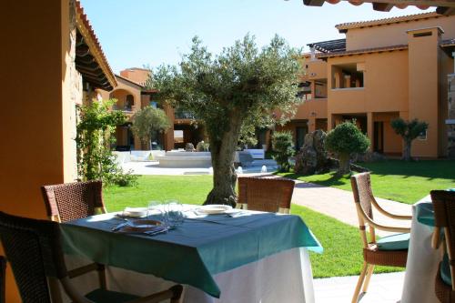 a table with a blue table cloth on top of a yard at Hotel Marana in Golfo Aranci