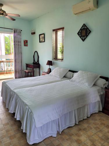 a large white bed in a room with at An Hoa Residence in Long Hai