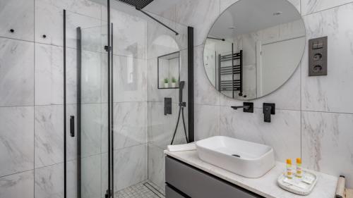 a bathroom with a shower and a sink and a mirror at Modern ElegancePrivate Pool in Fuengirola