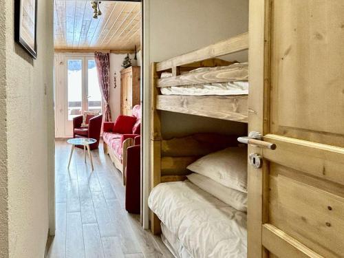 a room with two bunk beds and a living room at Studio rénové, 4 couchages, proche pistes et commerces - FR-1-330F-231 in La Salle Les Alpes