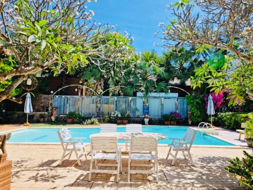 a patio with a table and chairs next to a pool at An Hoa Residence in Long Hai