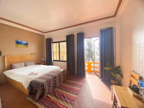 a bedroom with a bed and a large window at GO SAPA HOSTEL in Sa Pa