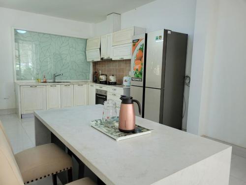 a kitchen with a counter top with a refrigerator at An Hoa Residence in Long Hai