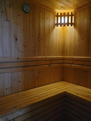 an empty wooden sauna with a clock on the wall at An Hoa Residence in Long Hai