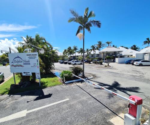 a street with a street sign and a palm tree at Dolphin Heads - Resort Unit - Absolute Beachfront! - Whitsunday Getaway! in Mackay