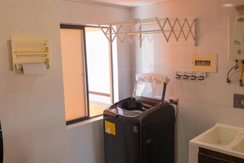 a bathroom with a trash can in the corner of a room at Apt Bedroom Apartment era With Doorman in Bucaramanga
