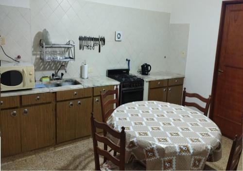 a kitchen with a stove and a sink and a table at Plaza Libertad in Santiago del Estero