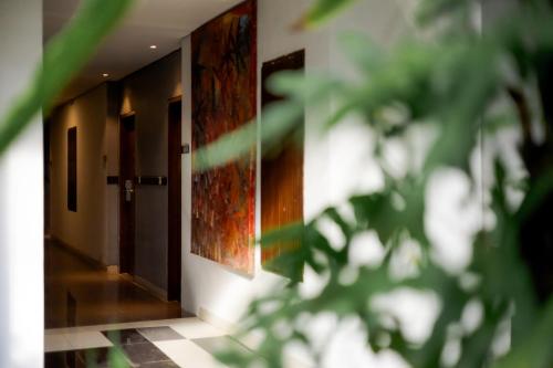 a hallway with a door and a tile floor at Fourteen Roses Boutique Hotel, Kuta in Legian