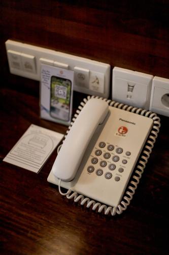 a telephone sitting on top of a wooden table at Fourteen Roses Boutique Hotel, Kuta in Legian