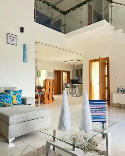 a living room with a couch and a glass table at 5 Star Villa minutes from Airport and Beaches in Sosúa